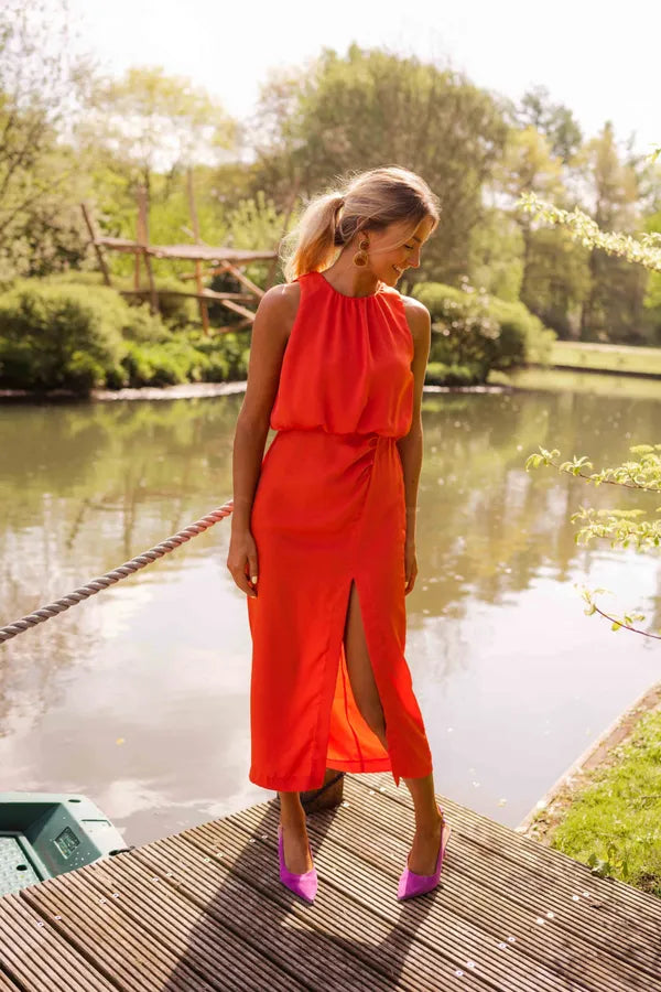Lacey orange halter neckline midi dress with front slit, full front view