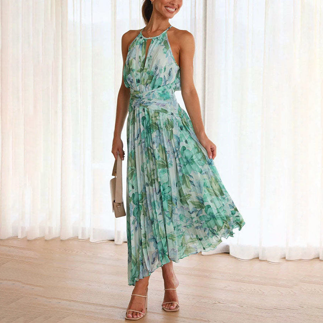 Green Bianca halter pleated maxi dress, front view on model beside sheer curtains