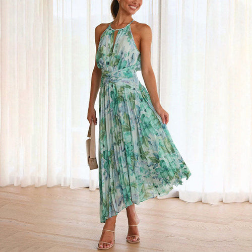 Green Bianca halter pleated maxi dress, front view on model beside sheer curtains