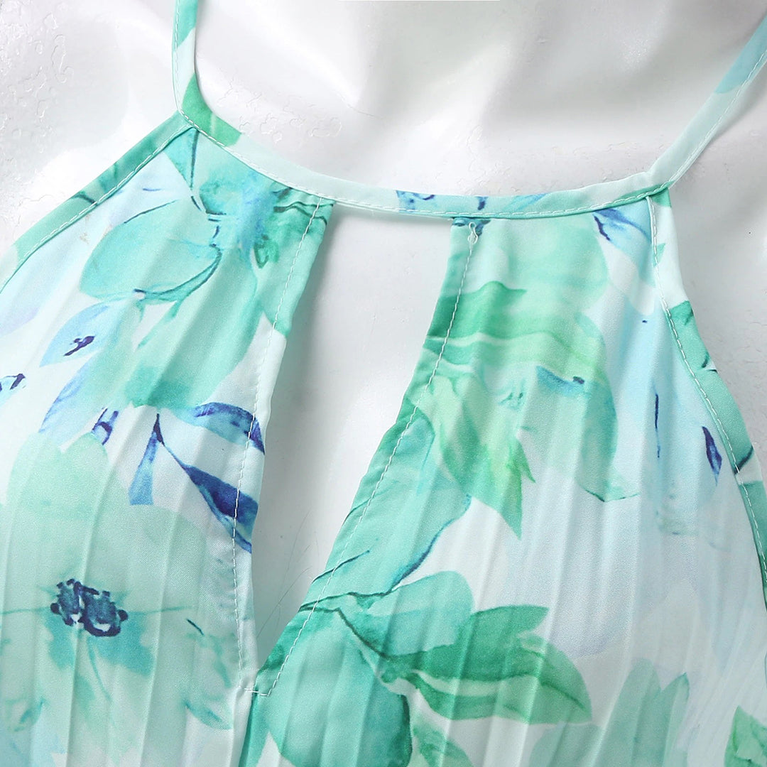 Close-up of the green floral pleating and halter neckline of the Bianca maxi dress