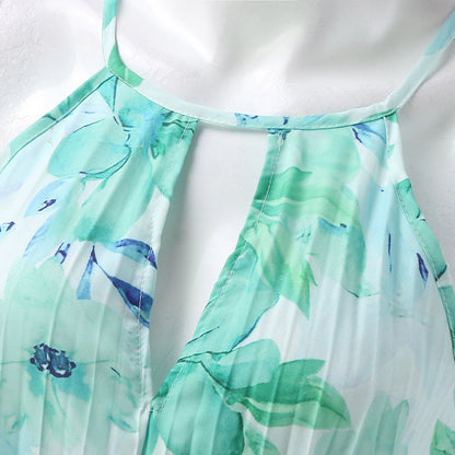 Close-up of the green floral pleating and halter neckline of the Bianca maxi dress