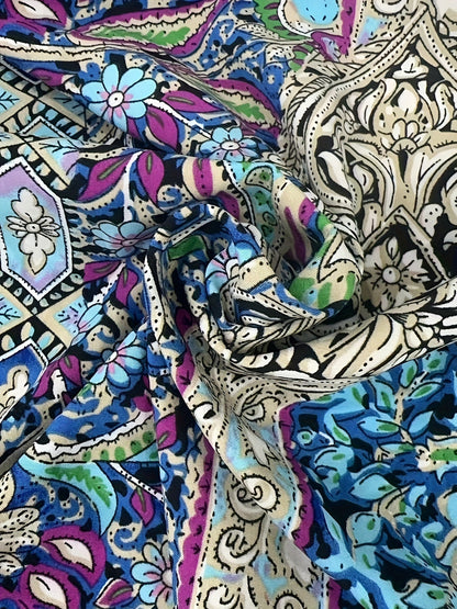 Fabric close-up of the sky blue paisley print on the Odile halter maxi dress