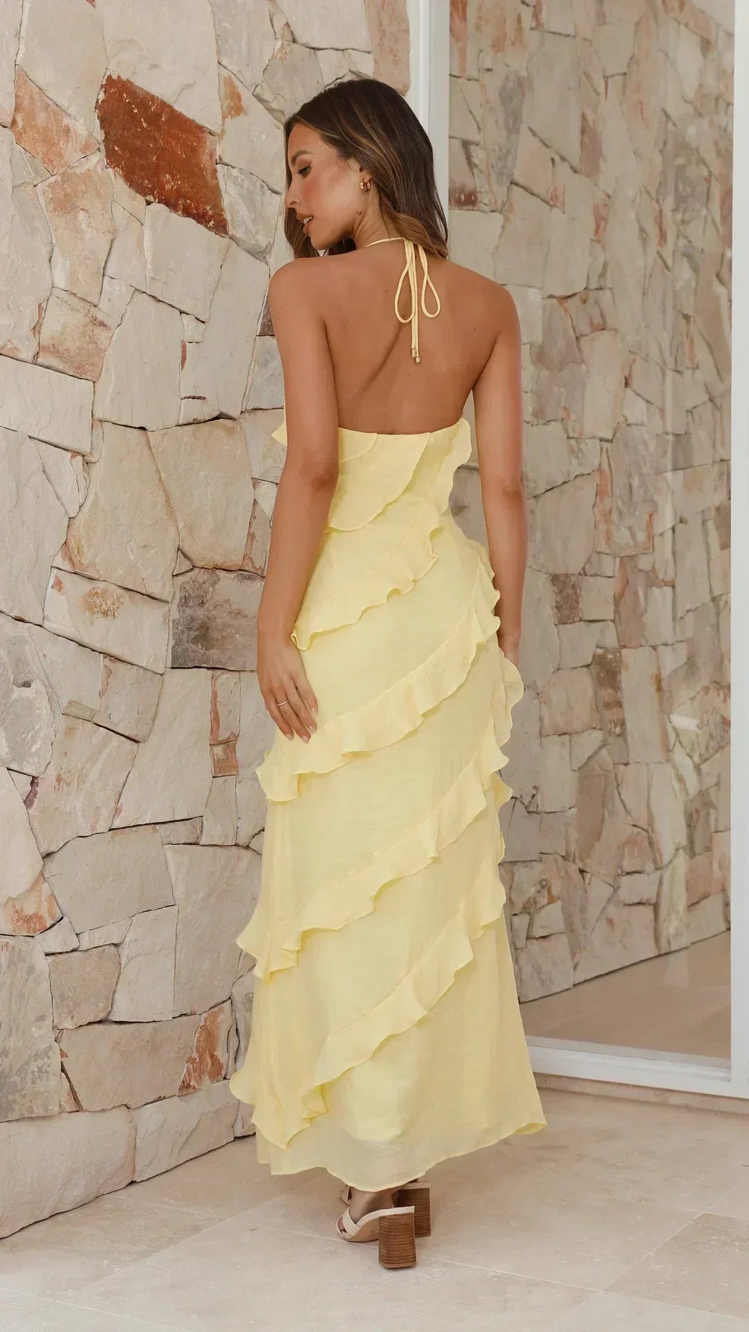 Cinnia yellow ruffle maxi dress from behind, halter tie straps and tiered ruffles