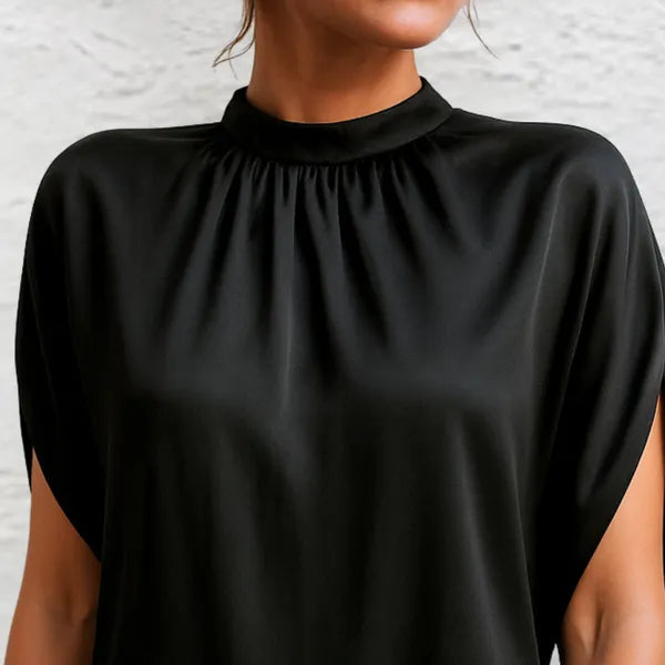 Detail of the gathered high neckline on the black Rose mini dress