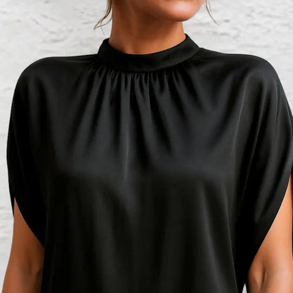 Detail of the gathered high neckline on the black Rose mini dress