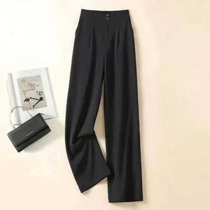 Gabrielle Women's High-Rise Drape Trousers in black, flat lay with handbag