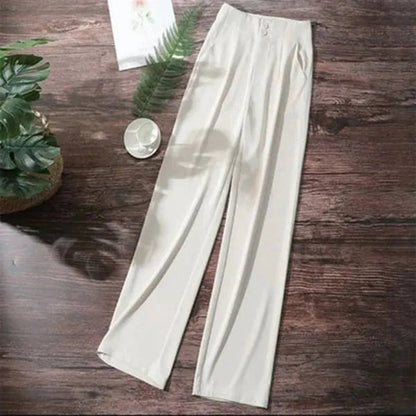 Gabrielle Women's High-Rise Drape Trousers in white, flat lay on wooden surface