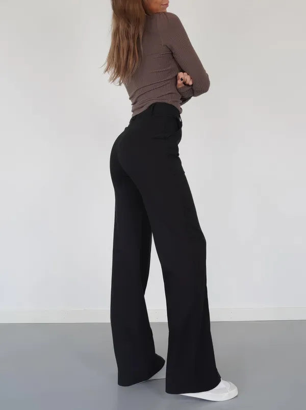 Eloise Women's High-Rise Pintuck Flowy Trousers in black, back view on model