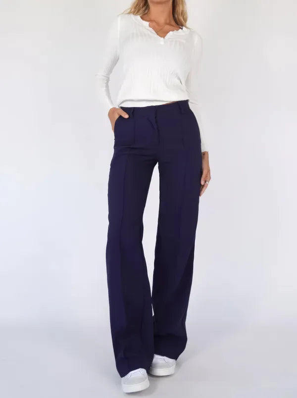 Eloise Women's High-Rise Pintuck Flowy Trousers in navy blue, front view on model