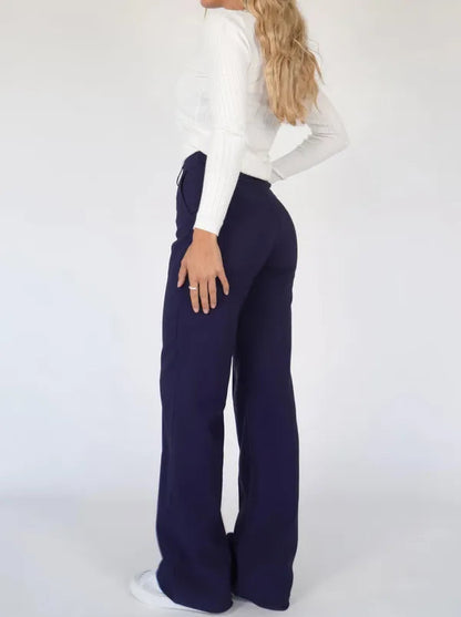 Eloise Women's High-Rise Pintuck Flowy Trousers in navy blue, back view on model