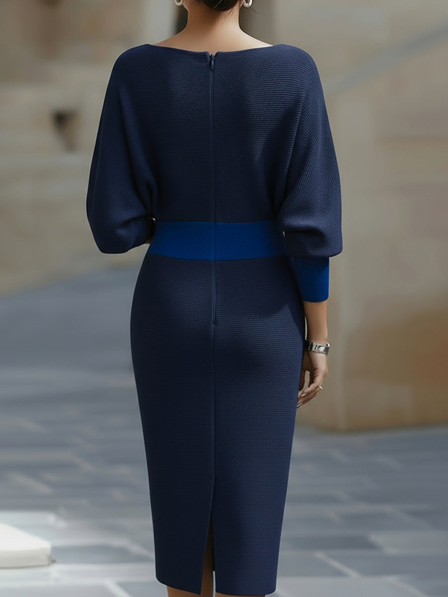 Back view of the navy blue Arabella knit bodycon midi dress with back slit