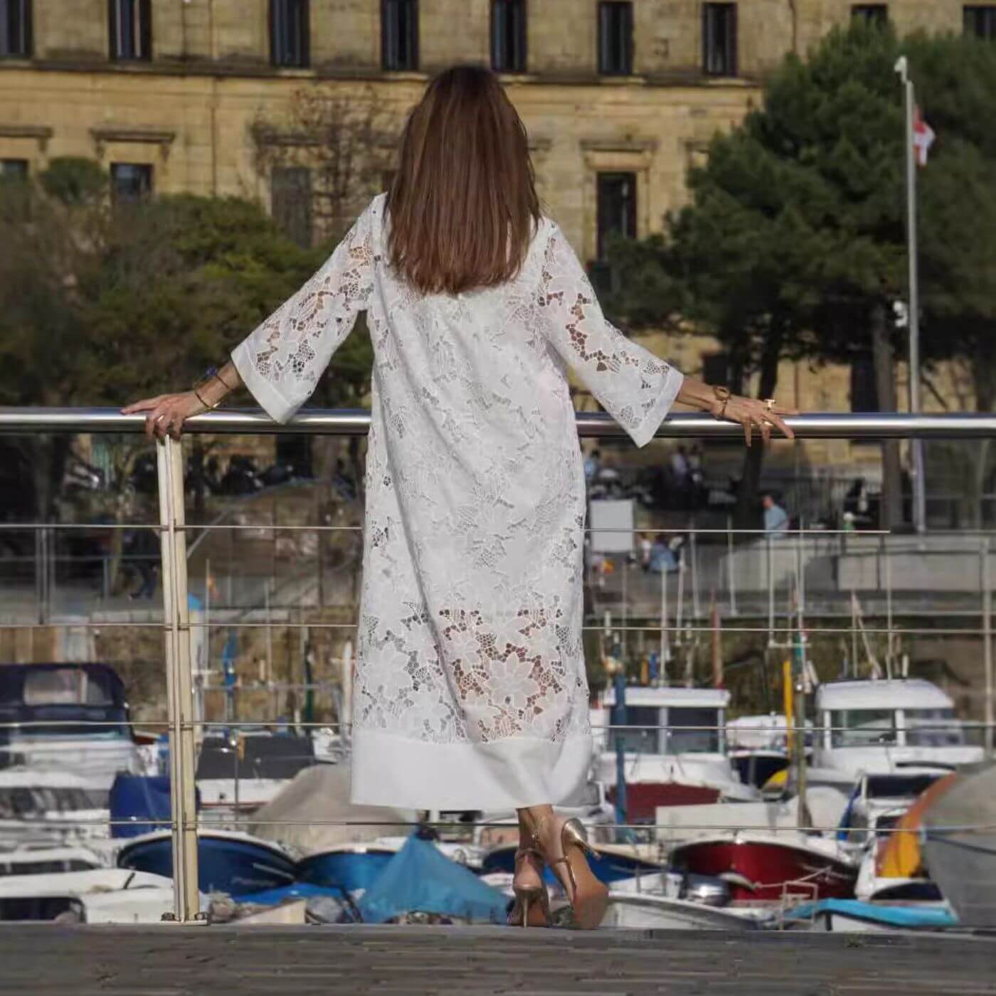 White Janica lace caftan maxi dress from behind, showing the sheer lace panels