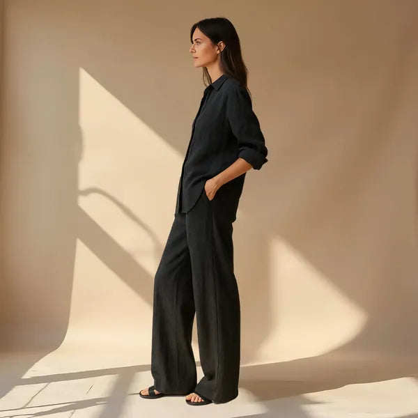 Hedda black linen shirt and wide leg trousers set, side profile view on model