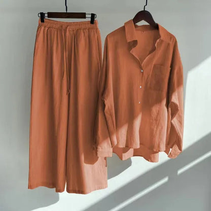 Floriana orange linen shirt and wide leg trousers set displayed on hangers
