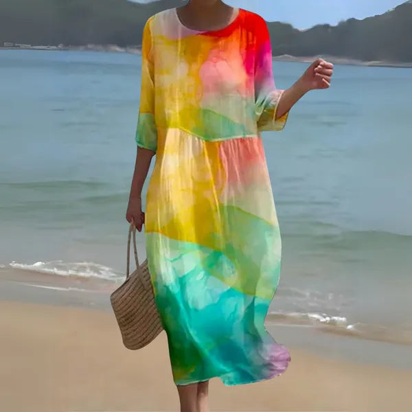 Multicolor Kallie long sleeve caftan maxi dress in rainbow print, beachside view