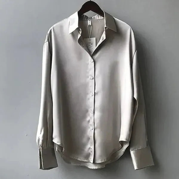 Women's Long Sleeve Collared Blouse in Gray satin, shown flat on a hanger – Nives