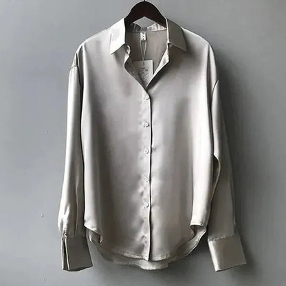 Women's Long Sleeve Collared Blouse in Gray satin, shown flat on a hanger – Nives