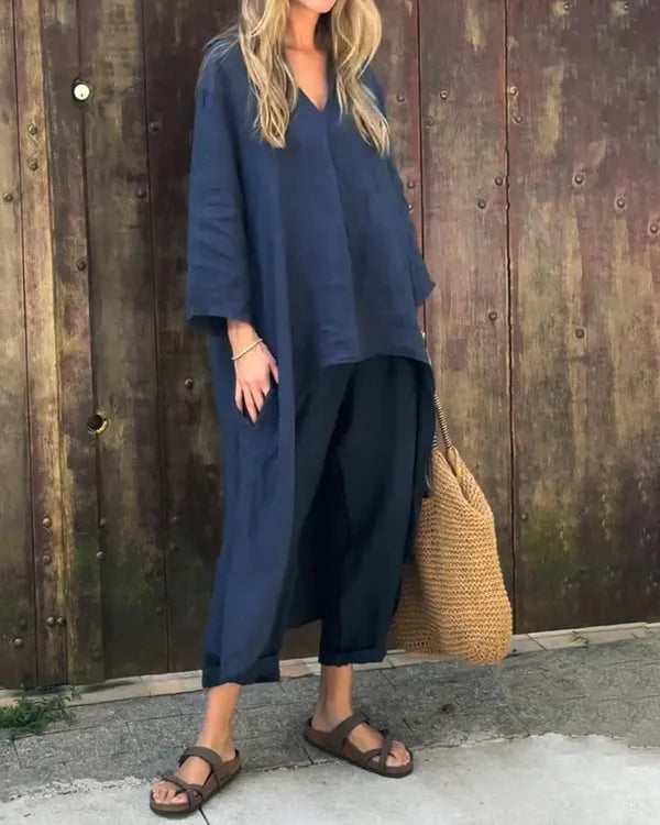 Fabiana navy blue tunic top and cropped trousers set, model with straw bag