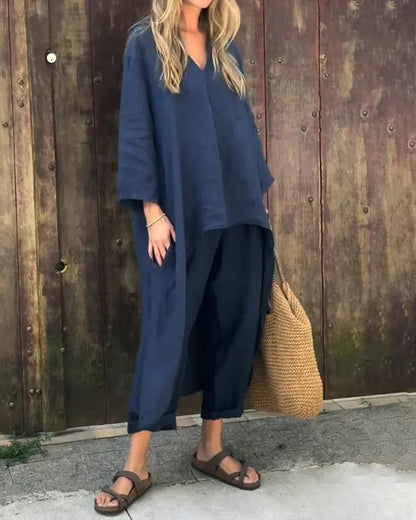 Fabiana navy blue tunic top and cropped trousers set, model with straw bag