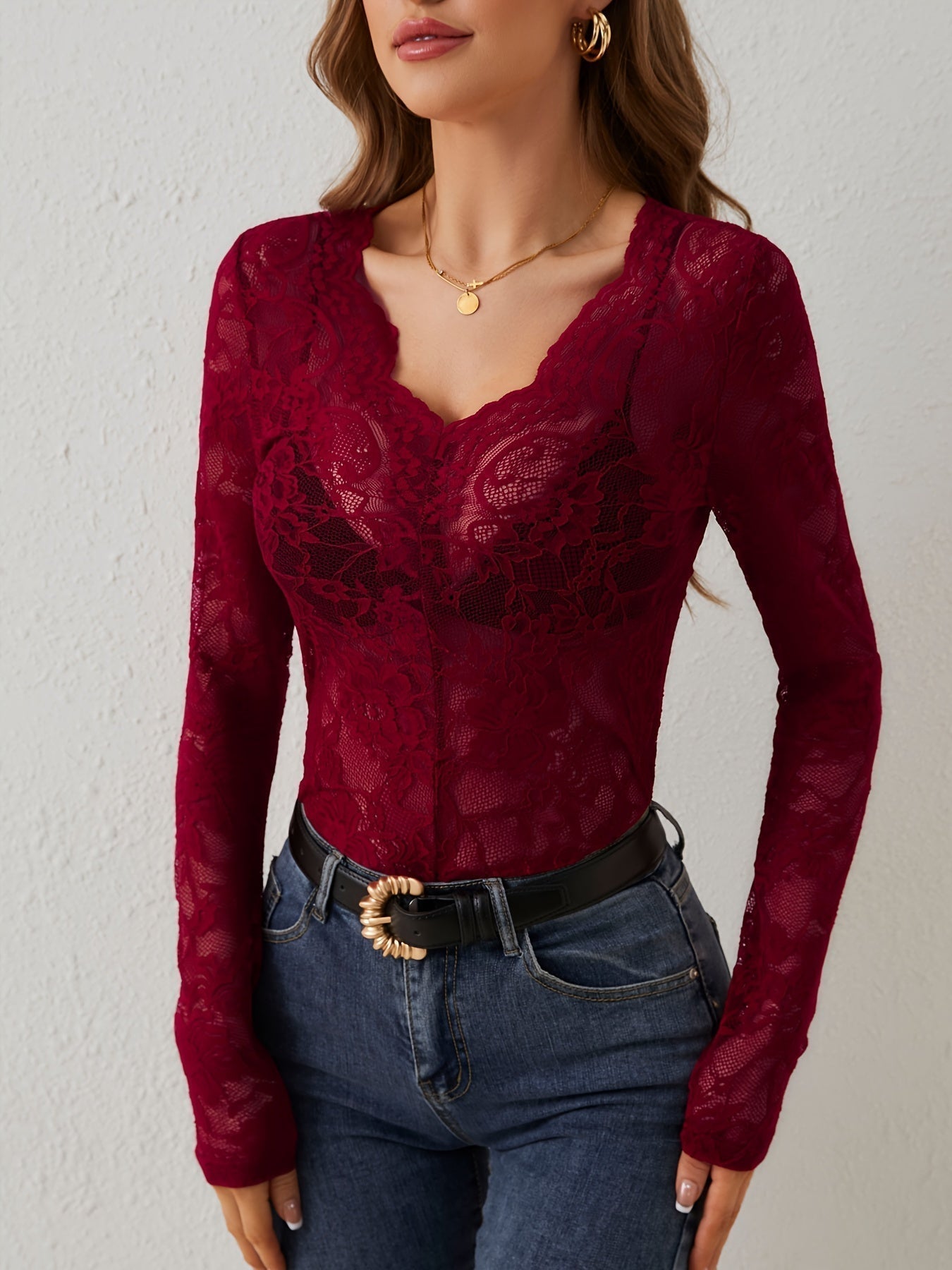 Maialen Women's Long Sleeve Lace V Neck Top in dark red, front view with jeans