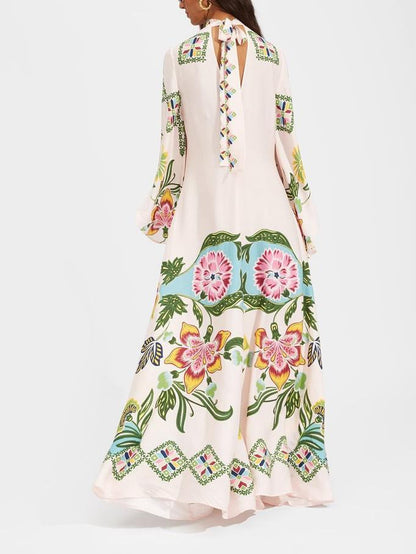 Cream Fern long sleeve printed maxi dress from behind, keyhole back and full skirt