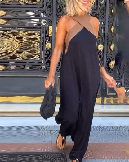 Hadrienne black halter maxi dress, side view showing the loose draping of the skirt