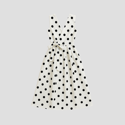 White Women's Midi Dress - Clarie with black polka dots, flat lay of the sleeveless wrap dress