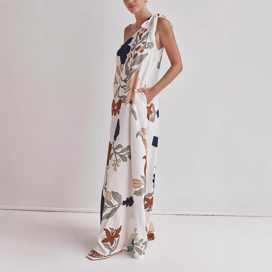 Side view of the Kora women's one shoulder floral maxi dress in apricot print