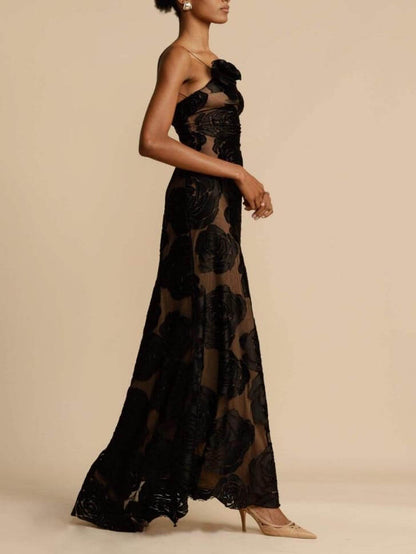 Side profile of the black Lucrezia one shoulder floral maxi dress on model