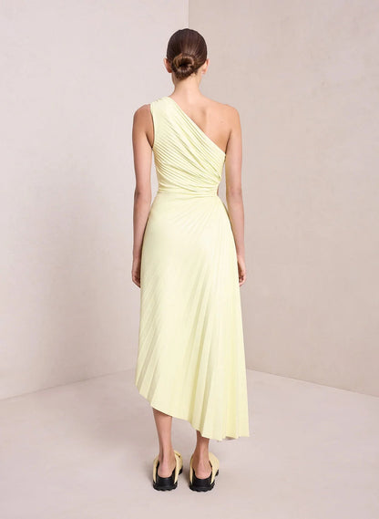 Rear view of the beige Inka one-shoulder pleated maxi dress and its hem