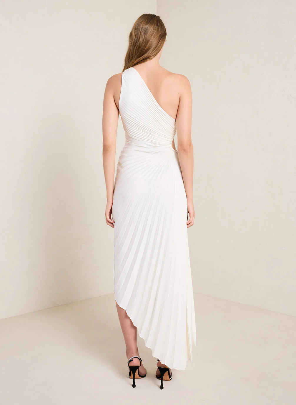 Back view of the Inka white one-shoulder pleated maxi dress, asymmetric hem