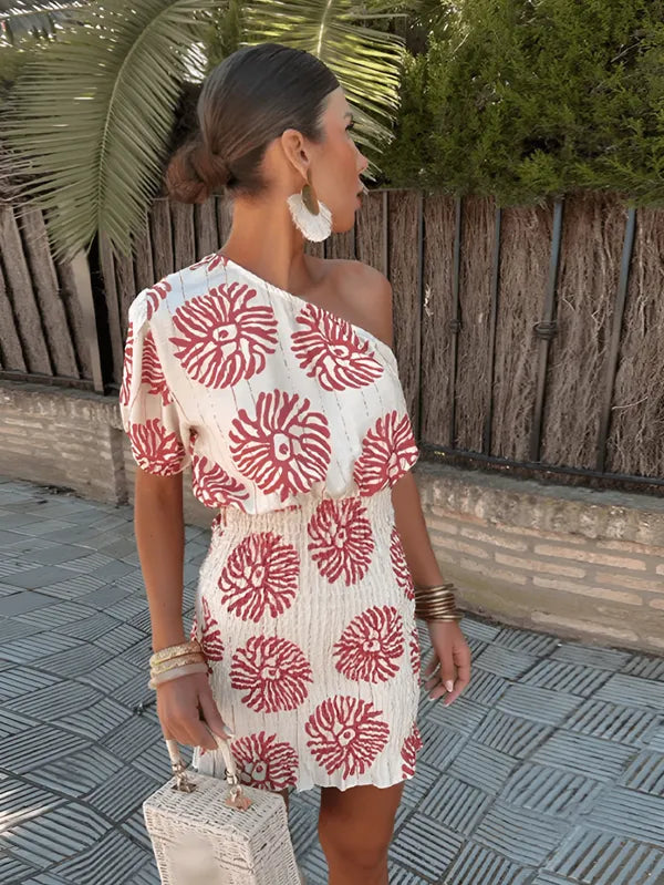 White One-Shoulder Smocked Mini Dress side view with red coral print and smocked skirt