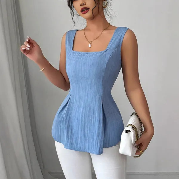 Dominika Women's Peplum Sleeveless Top in blue, front view with white pants and bag