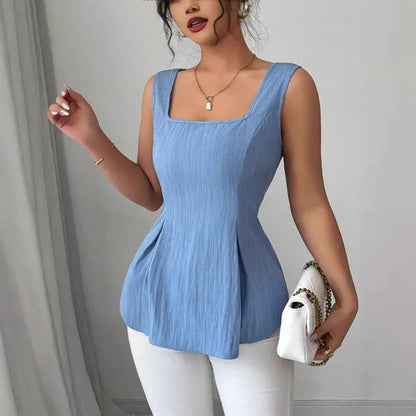 Dominika Women's Peplum Sleeveless Top in blue, front view with white pants and bag