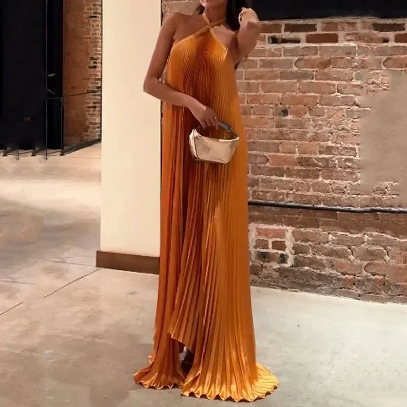Side view of the Hope orange pleated halter evening maxi dress on model