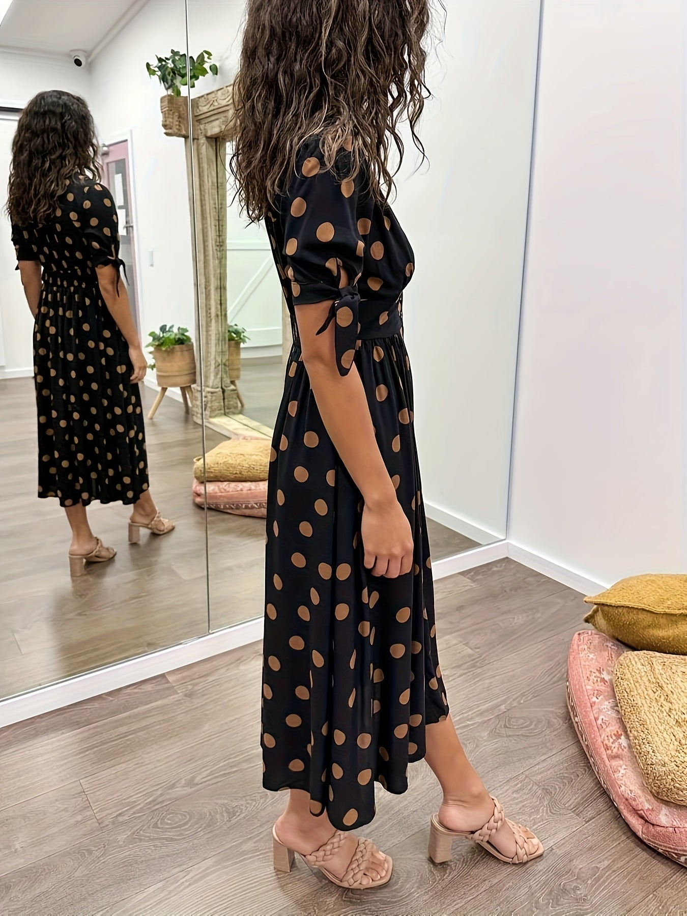 Black Women's Polka Dot V Neck Midi Dress - Amaris seen from the side, flowing polka dot skirt