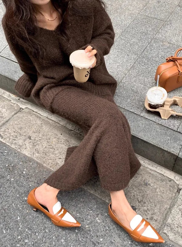 Janette brown knit set, seated close-up of the ribbed maxi skirt hemline