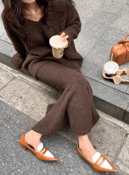 Janette brown knit set, seated close-up of the ribbed maxi skirt hemline