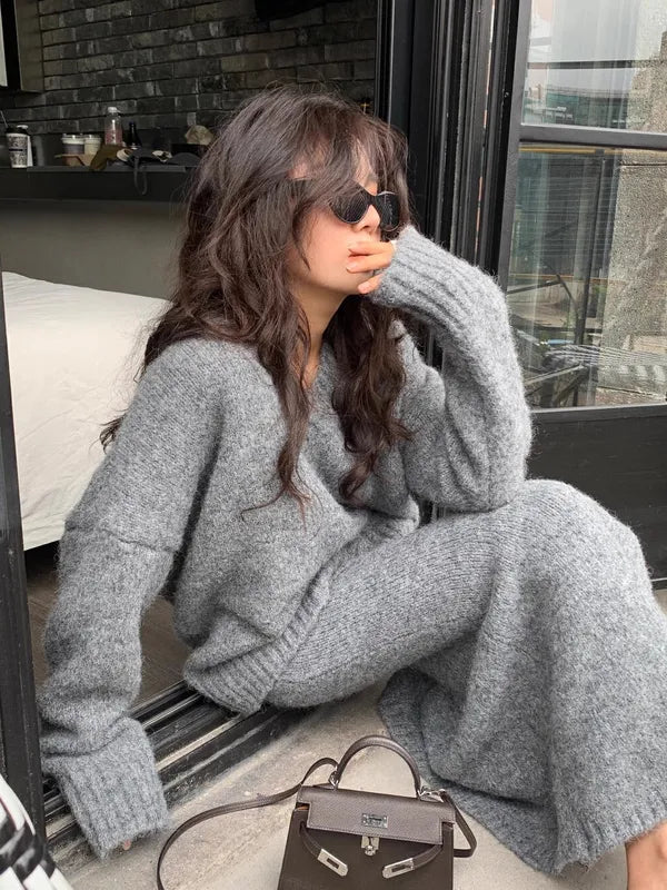 Janette gray knit two-piece set, model seated by a window side view