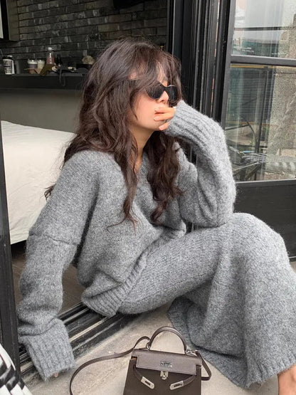 Janette gray knit two-piece set, model seated by a window side view