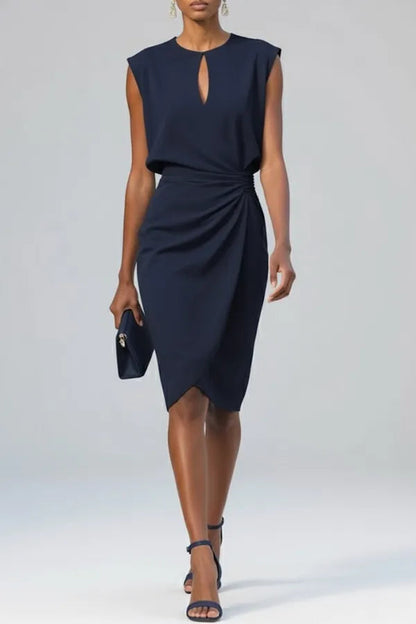 Sandy women's ruched midi dress in navy blue, front view on model with clutch