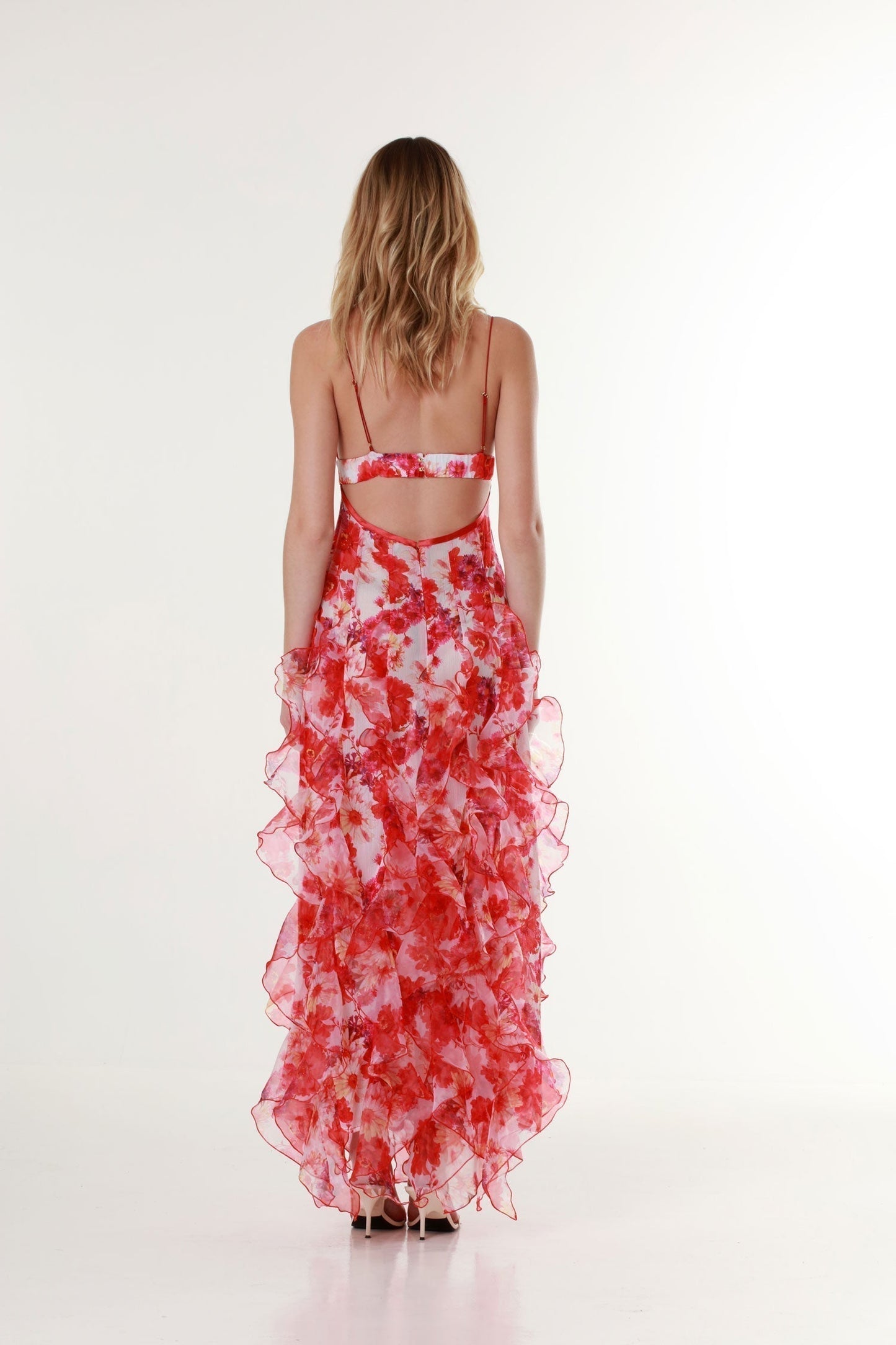Back view of the red Quinta ruffle floral maxi dress with open back