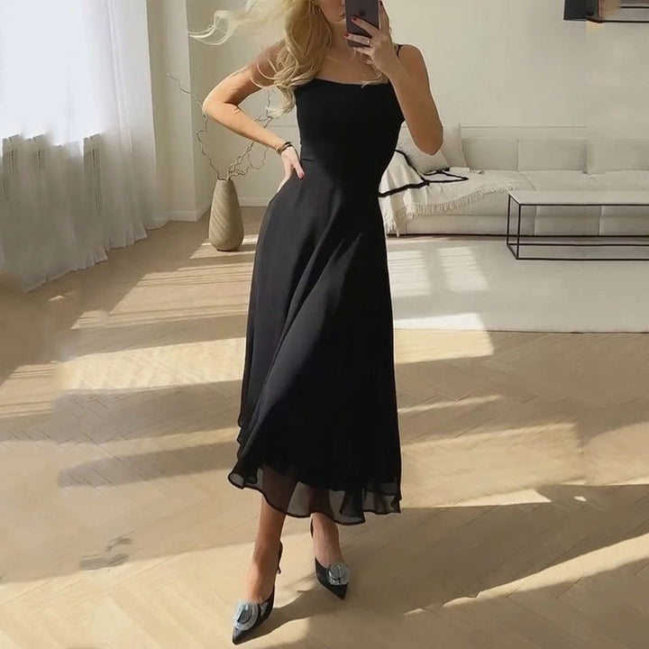 Georgiana women's satin cocktail midi dress in black, front view on model indoors