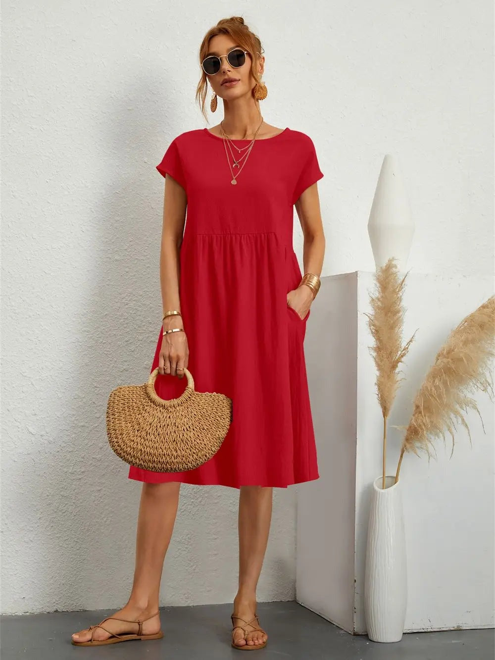 Henrietta women's shift summer midi dress in red, front view on model with straw bag
