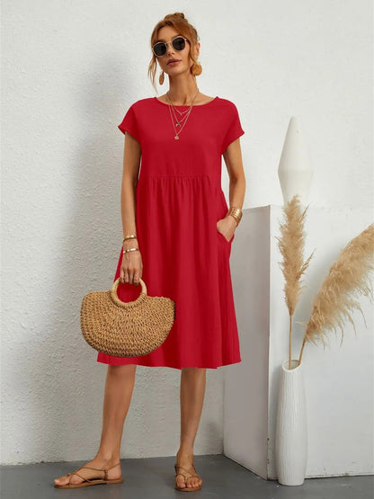 Henrietta women's shift summer midi dress in red, front view on model with straw bag