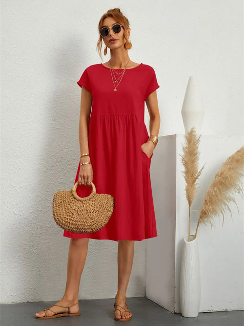 Henrietta women's shift summer midi dress in red, front view on model with straw bag