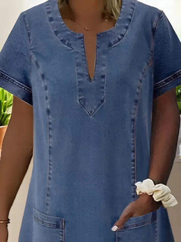 Detail of Blue Denim Shift Dress split V neckline topstitching and patch pocket