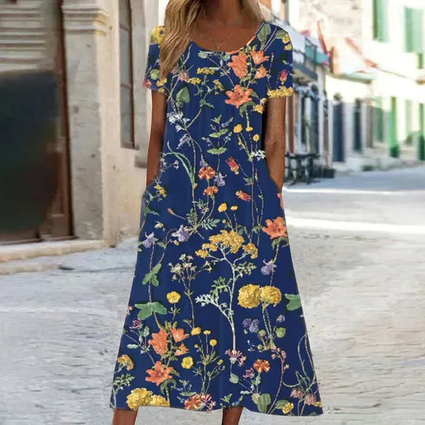 Dark blue Florina floral maxi dress with pockets, front view on a street