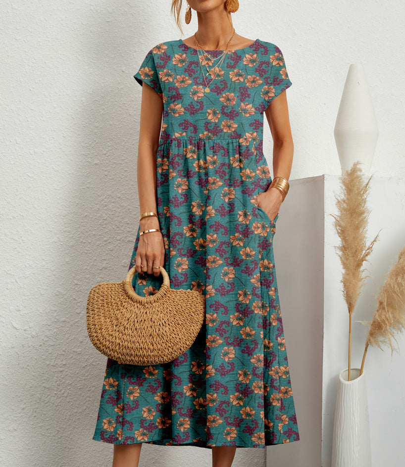 Anastazja women's short sleeve midi dress in blue floral print, front view with straw bag