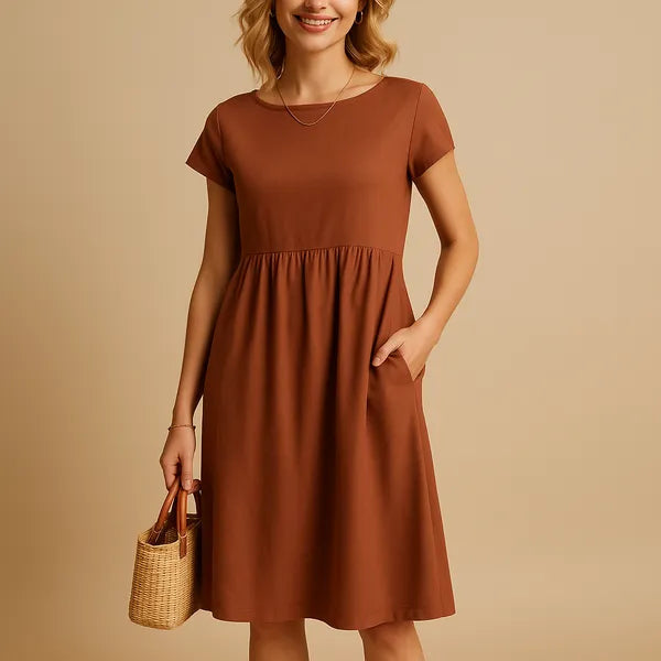 Rust Orange Short Sleeve Babydoll Dress front view with empire seam and pockets